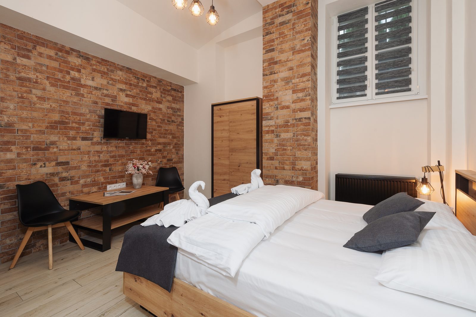 Double room with exposed brick wall